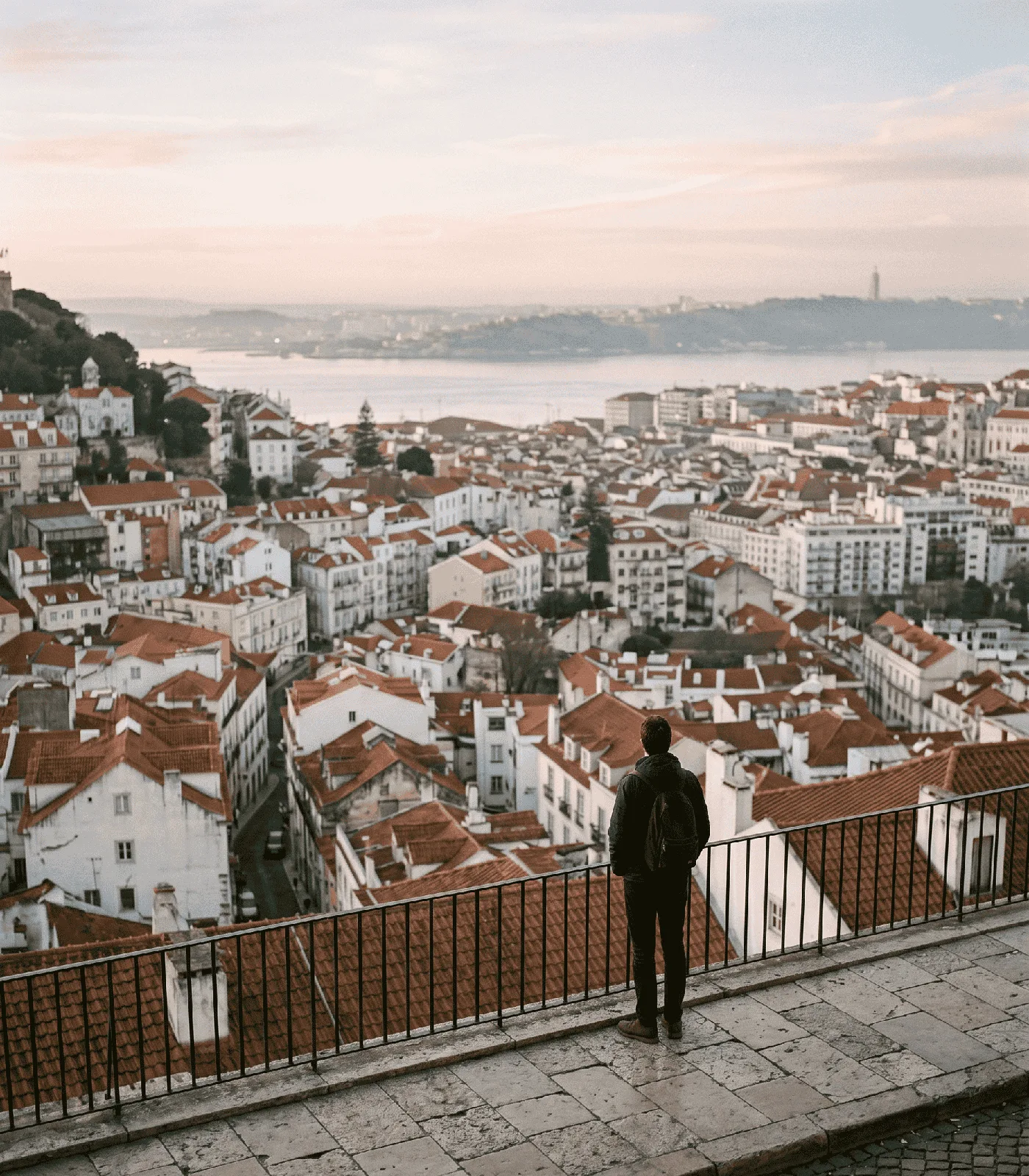 Miradouro da Graça at dawn, looking south over Alfama rooftops toward the Tagus, Lisbon